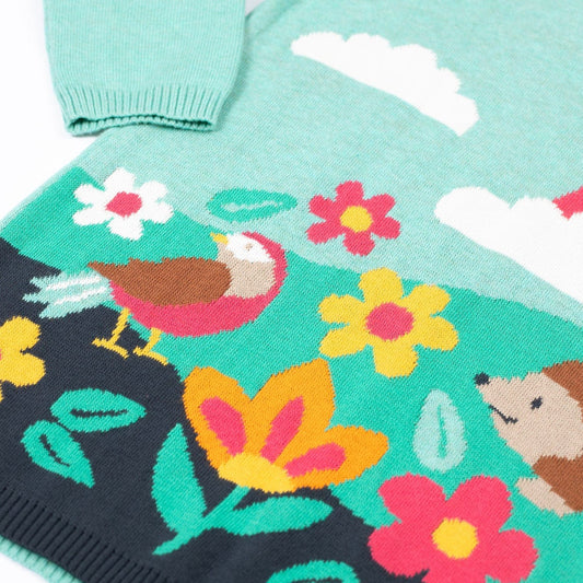 Children's sweater with floral and animal pattern on a white background