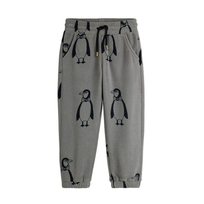 Grey fleece pants with penguin pattern on a white background