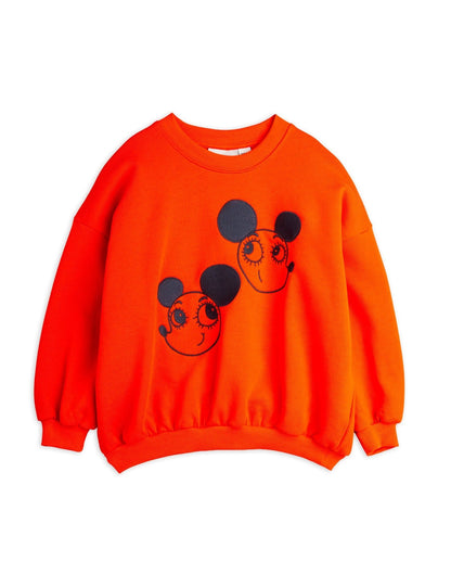 Orange sweatshirt with black mouse face designs on a white background