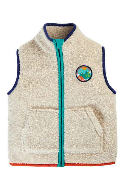 Fleece vest from Frugi in beige, red and blue taping and get outside patch it on left chest.