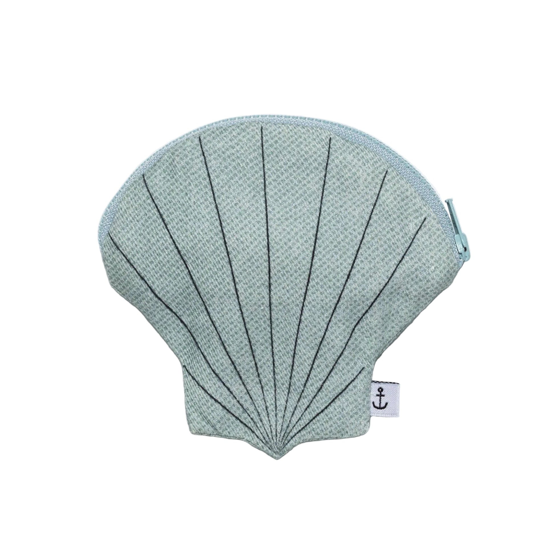 Shell-shaped pouch with textured surface on a light gray background