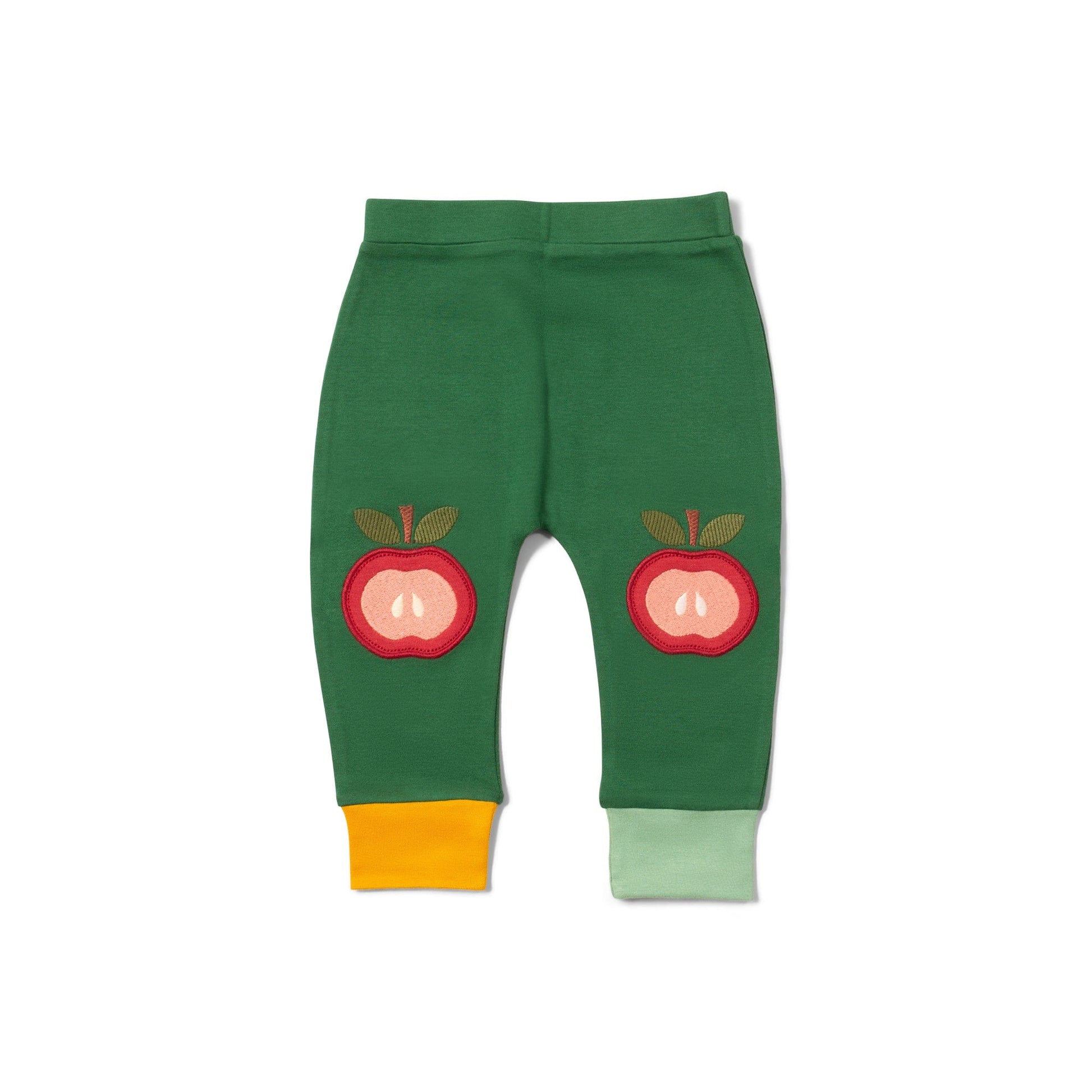 Green baby leggings with red apple designs on a white background