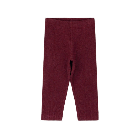 A pair of ribbed knit leggings in a deep burgundy red