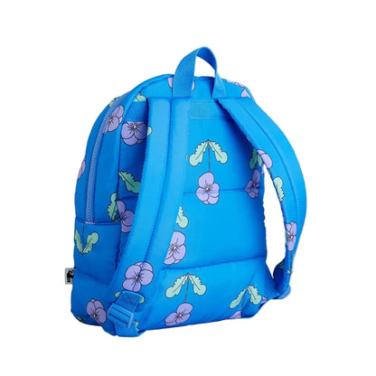 A bright blue backpack with a pattern of purple flowers and green leaves, shown from the back against a light gray background.