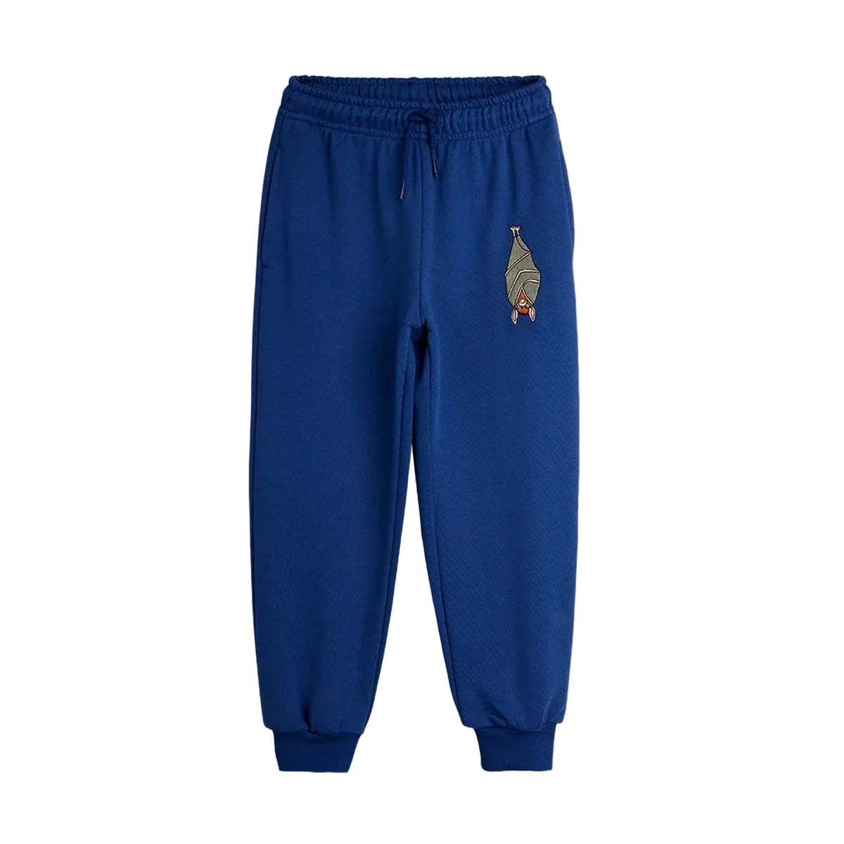 A pair of royal blue sweatpants with a drawstring waist and ribbed cuffs, featuring a small embroidered bird graphic on the left chest, shown against a light gray background.