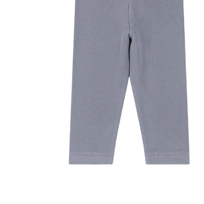 Light blue ribbed knit leggings shown flat against a pale pink background.