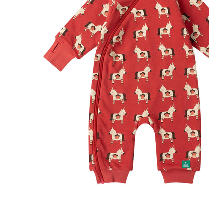 A red long-sleeve baby romper with a front zipper and an all-over print of cartoon horses, shown on a light pink background.