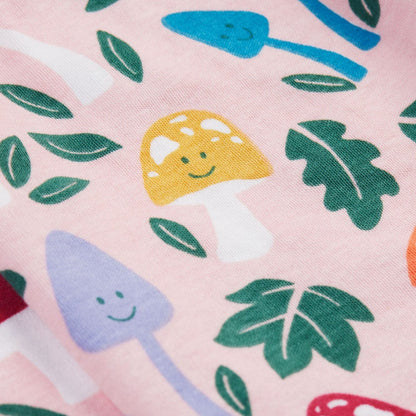 Pattern of colorful mushrooms and leaves on a pink background